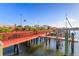 Community boat dock with red railings and wood flooring with boats docked at 8707 Sailmaker Ct, Tampa, FL 33615