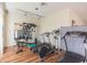 Home gym with hardwood floors, mirror, and multiple workout machines at 8707 Sailmaker Ct, Tampa, FL 33615