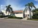 Exterior view of Spinnaker Cove building with tropical landscaping and palm trees at 8707 Sailmaker Ct, Tampa, FL 33615