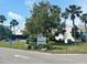 Spinnaker Cove exterior with lush landscaping, palm trees and community signage at 8707 Sailmaker Ct, Tampa, FL 33615