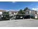 Condos with a covered parking area on a sunny day showing stucco exteriors and metal roofs at 8707 Sailmaker Ct, Tampa, FL 33615