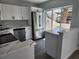 Updated kitchen featuring white cabinets, stainless steel appliances, and stylish backsplash at 8707 Sailmaker Ct, Tampa, FL 33615