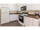 A kitchen with white cabinets, modern appliances, and stylish countertops at 8707 Sailmaker Ct, Tampa, FL 33615