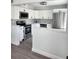Updated kitchen featuring white cabinets, stainless steel appliances, and stylish backsplash at 8707 Sailmaker Ct, Tampa, FL 33615