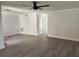 Living room with gray floors and white trim plus doors to other rooms. The room is bright and airy at 8707 Sailmaker Ct, Tampa, FL 33615
