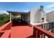 Spacious outdoor deck with red flooring and railing that overlooks the water and surrounding landscape at 8707 Sailmaker Ct, Tampa, FL 33615