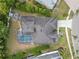 Aerial view of the backyard with a screened-in pool, patio and fire pit area at 8833 Bel Meadow Way, Trinity, FL 34655
