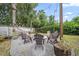 Charming backyard with a fire pit, ample seating, and string lights at 8833 Bel Meadow Way, Trinity, FL 34655