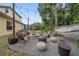 Cozy backyard featuring a fire pit, hammock, string lights, and ample seating for outdoor entertaining at 8833 Bel Meadow Way, Trinity, FL 34655