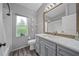 Stylish bathroom with a gray vanity, large mirror, and shower-tub combo at 8833 Bel Meadow Way, Trinity, FL 34655
