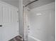 Bright bathroom features a white shower-tub combo with a tiled wall and decorative curtain at 8833 Bel Meadow Way, Trinity, FL 34655