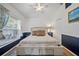 Cozy bedroom featuring a queen-sized bed, soft lighting, and a bright window at 8833 Bel Meadow Way, Trinity, FL 34655