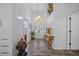 Elegant foyer with double doors, chandelier, and decorative console table at 8833 Bel Meadow Way, Trinity, FL 34655