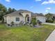 Beautiful single-story home featuring a well-maintained lawn, mature landscaping, and attached two car garage at 8833 Bel Meadow Way, Trinity, FL 34655