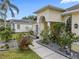 Home exterior with lush landscaping and a stone walkway leading to the home at 8833 Bel Meadow Way, Trinity, FL 34655