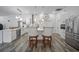 Bright kitchen with white cabinets, stainless appliances, and an island with barstool seating at 8833 Bel Meadow Way, Trinity, FL 34655