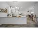 Spacious kitchen with white cabinetry, stainless steel appliances, and a large center island at 8833 Bel Meadow Way, Trinity, FL 34655