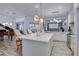 Open-concept kitchen area with a kitchen island, stainless steel appliances, and a piano at 8833 Bel Meadow Way, Trinity, FL 34655