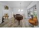 Elegant living room featuring a grand piano, modern lighting, and access to outdoor space at 8833 Bel Meadow Way, Trinity, FL 34655