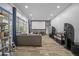 Home theater with large screen, surround sound, and a comfortable gray sofa at 8833 Bel Meadow Way, Trinity, FL 34655