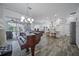 Bright living room with piano, kitchen and access to the patio at 8833 Bel Meadow Way, Trinity, FL 34655