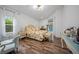 Cozy main bedroom with floral bedding, ensuite bath, and pool views at 8833 Bel Meadow Way, Trinity, FL 34655