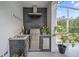Outdoor kitchen features a built-in grill, sink, and stylish tile backsplash at 8833 Bel Meadow Way, Trinity, FL 34655
