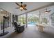 Spacious outdoor living space includes an outdoor kitchen and overlooks the screened-in pool at 8833 Bel Meadow Way, Trinity, FL 34655