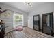 An inviting room featuring two wine fridges, a window, and wood-look flooring at 8833 Bel Meadow Way, Trinity, FL 34655
