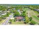 Aerial view featuring a home with a screened in pool and adjacent golf course, showcasing the community's layout at 10 Arbor Ln, Oldsmar, FL 34677