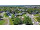 Aerial view of a charming home nestled among mature trees in a serene, golf course community at 10 Arbor Ln, Oldsmar, FL 34677