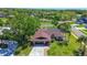 Aerial view of a one story home with a large backyard, screened in pool, golf course, and mature trees at 10 Arbor Ln, Oldsmar, FL 34677