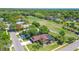 Aerial view showcasing a home with a screened in pool located near a golf course fairway in a lush neighborhood at 10 Arbor Ln, Oldsmar, FL 34677