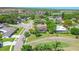 Expansive aerial view of a community featuring homes and a golf course in a lush, green landscape at 10 Arbor Ln, Oldsmar, FL 34677