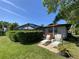 Cozy backyard featuring a screened-in lanai and lounge chairs at 10 Arbor Ln, Oldsmar, FL 34677