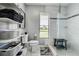 Well-lit bathroom with open shelving and glass shower stall at 10 Arbor Ln, Oldsmar, FL 34677