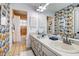 This bathroom features a double sink vanity and separate access to a shower and toilet at 10 Arbor Ln, Oldsmar, FL 34677
