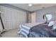 This bedroom includes a mirrored dresser and a large closet with multiple doors at 10 Arbor Ln, Oldsmar, FL 34677