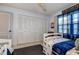 Cozy bedroom with a ceiling fan, a large closet and a pair of twin beds at 10 Arbor Ln, Oldsmar, FL 34677