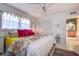 This bedroom has bright decor, a closet with doors and an entry to another room at 10 Arbor Ln, Oldsmar, FL 34677