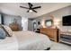 This cozy bedroom features a ceiling fan and decoratively framed mirror on the dresser at 10 Arbor Ln, Oldsmar, FL 34677