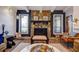 Cozy living room featuring a striking stone fireplace and wood laminate floors at 10 Arbor Ln, Oldsmar, FL 34677