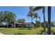 Well-maintained home featuring mature palm trees and a stone chimney at 10 Arbor Ln, Oldsmar, FL 34677