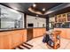 Bright kitchen featuring tile floors, black countertops and wooden cabinets, leading to the living space at 10 Arbor Ln, Oldsmar, FL 34677