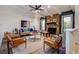 Open-concept living room with a stone fireplace, ceiling fan and comfortable seating at 10 Arbor Ln, Oldsmar, FL 34677