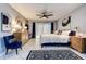 Well decorated main bedroom with a view of the backyard, a comfy blue chair and tile flooring at 10 Arbor Ln, Oldsmar, FL 34677