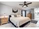 Tastefully decorated main bedroom featuring tiled floors, ceiling fan and access to the ensuite bathroom at 10 Arbor Ln, Oldsmar, FL 34677