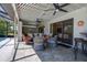 Inviting covered patio features comfortable seating, ceiling fans, and stylish decor at 10 Arbor Ln, Oldsmar, FL 34677