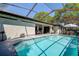 Inviting screened-in pool with open-air structure and view of the lanai at 10 Arbor Ln, Oldsmar, FL 34677