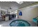 Covered patio includes a hot tub and seating with a partial view of the pool at 10 Arbor Ln, Oldsmar, FL 34677